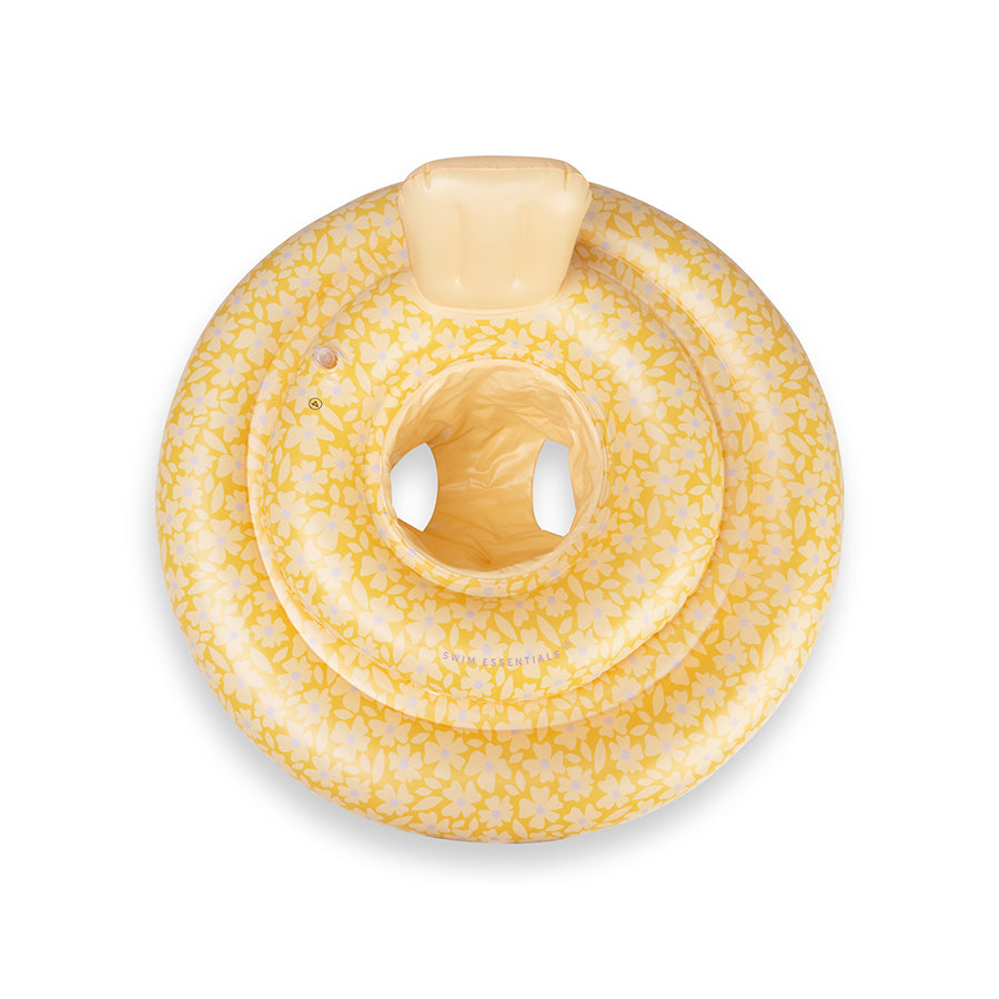 The top of a yellow baby float with flowers and purple polka dots on a white background