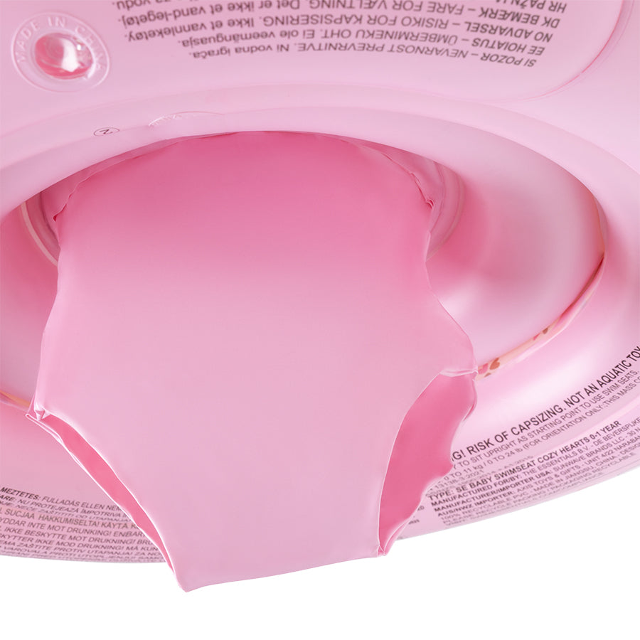 Close-up of the pink bottom of the baby float with warnings on it on a white background