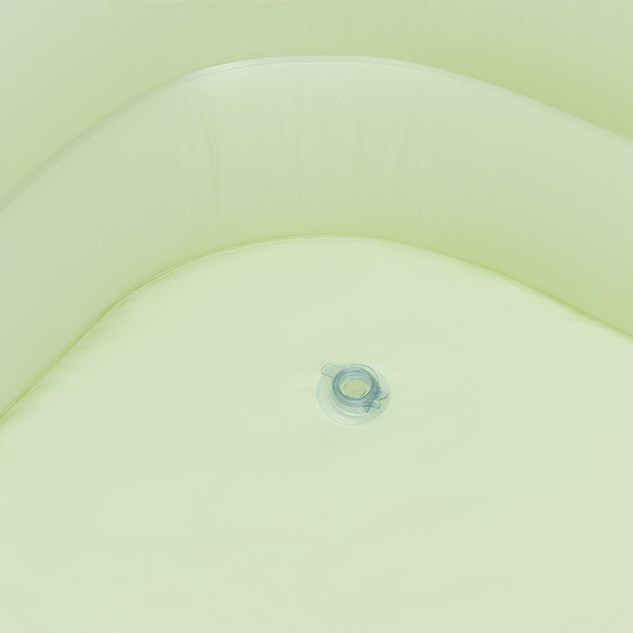 Close-up of a light green fabric texture with the valve