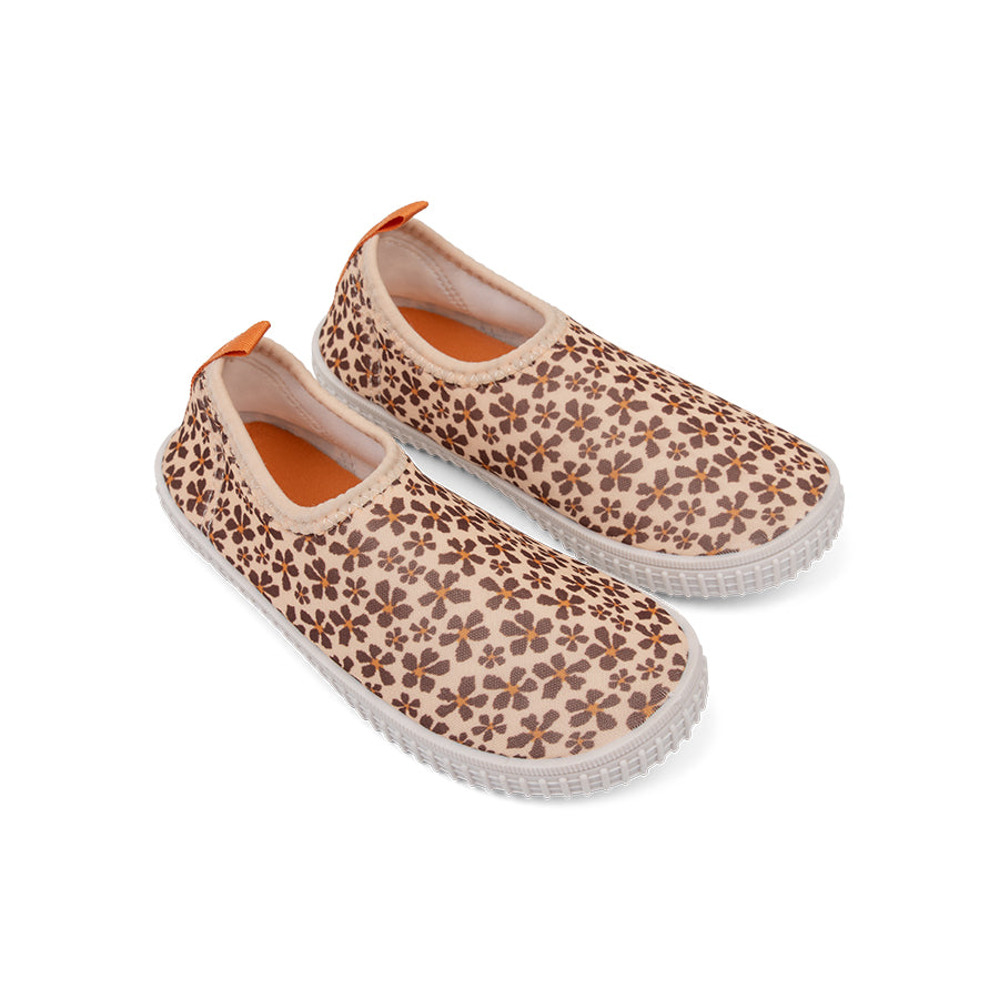 Pair of floral-patterned water shoes with white soles on a white background