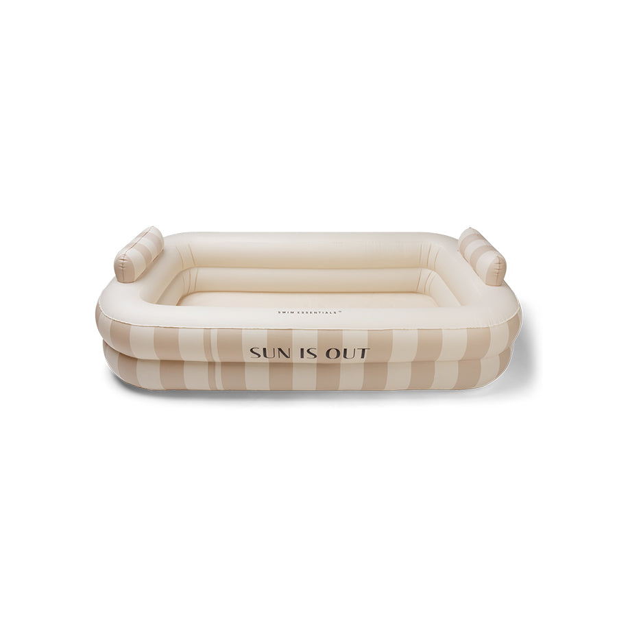 Inflatable pool with beige stripes with 'Sun is Out' text on it on a white background