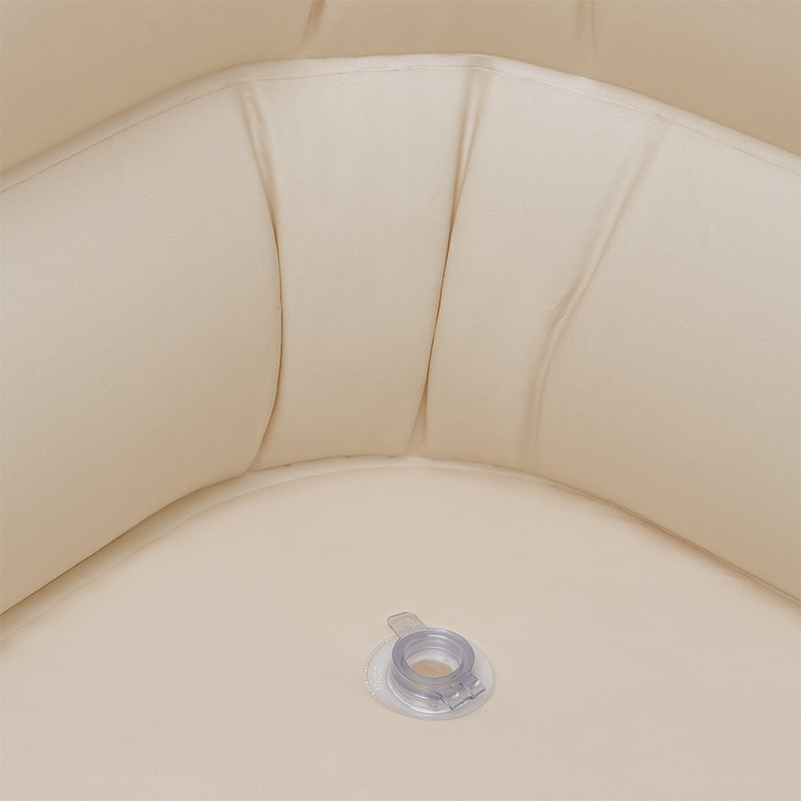Close-up of a beige inflatable pool with a inflatable spout.