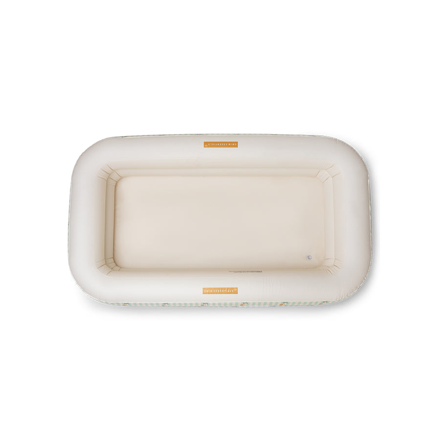 The inside of an inflatable pool with the swim essentials logo on it on a white background.