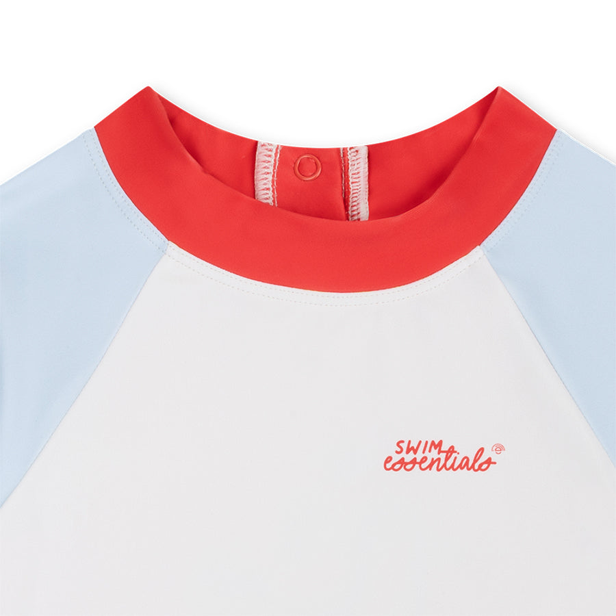 Close-up of a children's white swim shirt with red collar and light blue sleeves on a white background.