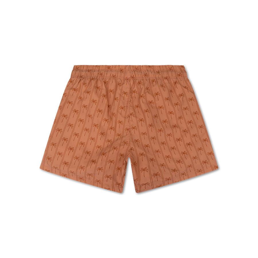 The back of men's swim shorts. They are brown and feature stripes and palm trees. There is also a white background.