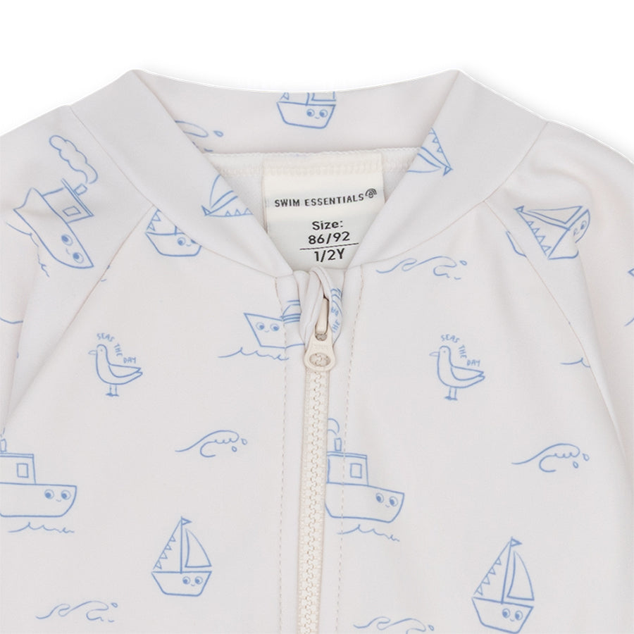 Close-up of a white swimsuit with blue sea prints on a white background