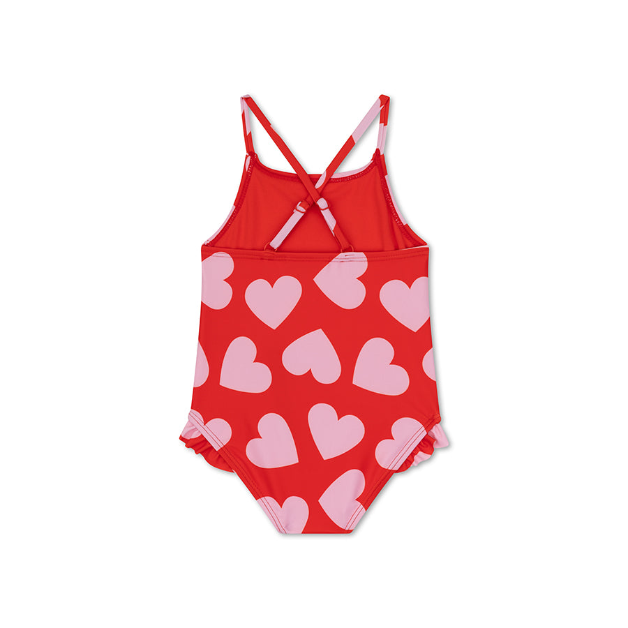 Red swimsuit with pink heart patterns on a white background