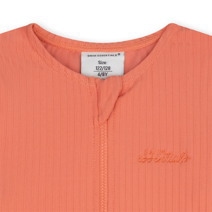 Close-up of the pink bay swimsuit with the swim essentials logo and a size label on a white background