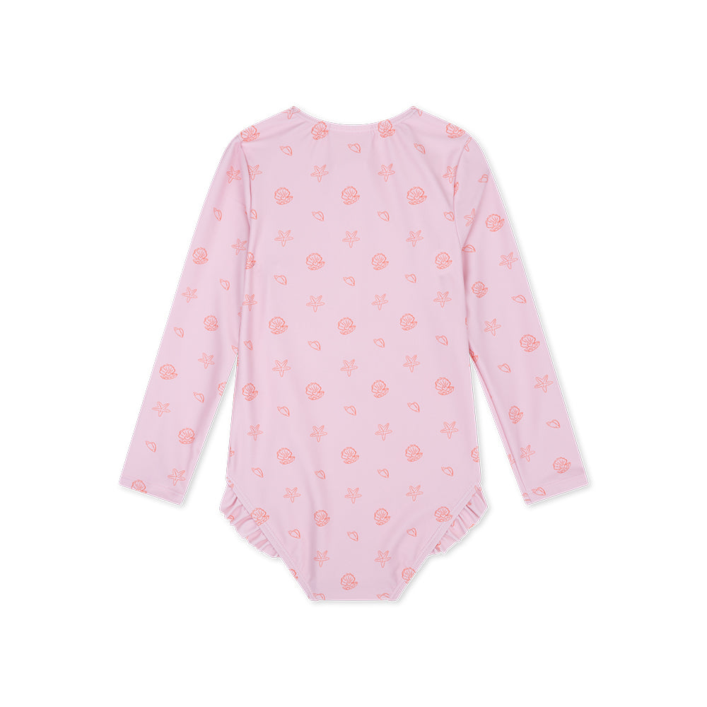 The back of the pink Shell Tastic girls swimsuit with long sleeves with a seashell-pattern with ruffles on a white background.