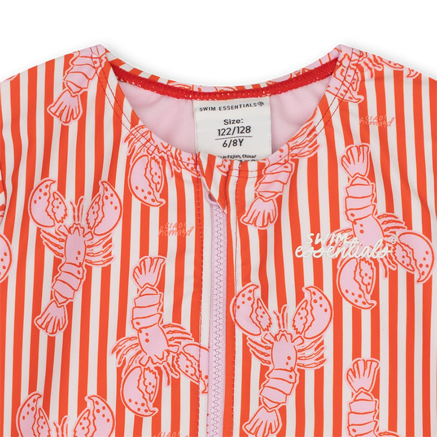 Close-up of the red and white striped Lobster-swimsuit with the swim essentials logo and a size label with a white background.