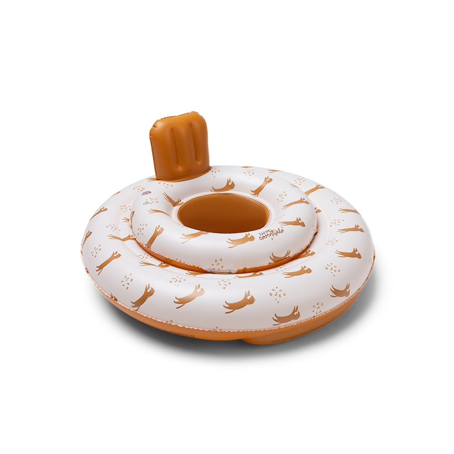 The baby float features the ‘Roamer’ print. The top is beige with a tiger and paw print. The bottom and neck support of the baby float are brown. 