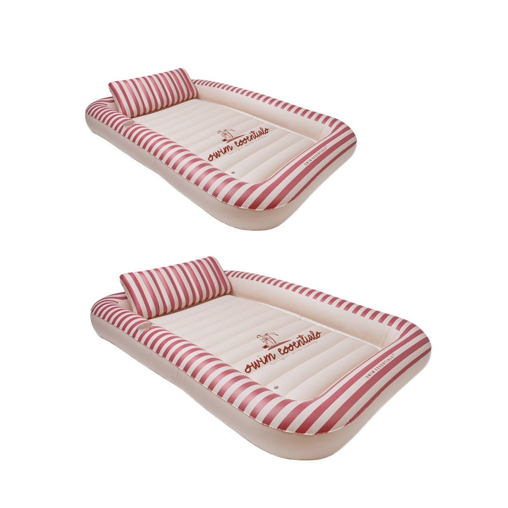Two inflatable tanning pools with red and beige striped edges. The centre of the pool is beige, featuring the Swim Essentials logo in the middle. The pools also come with a neck support. This is shown against a white background.