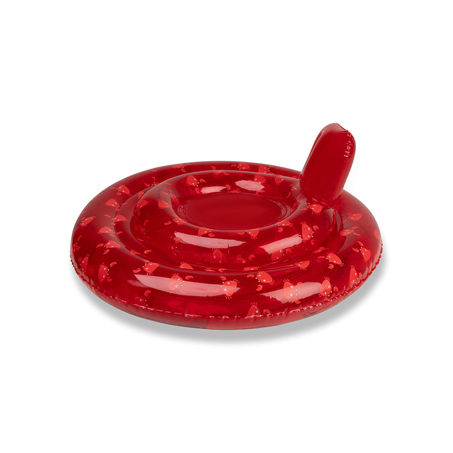 The side of a transparant red baby float with crabs on it on a white background