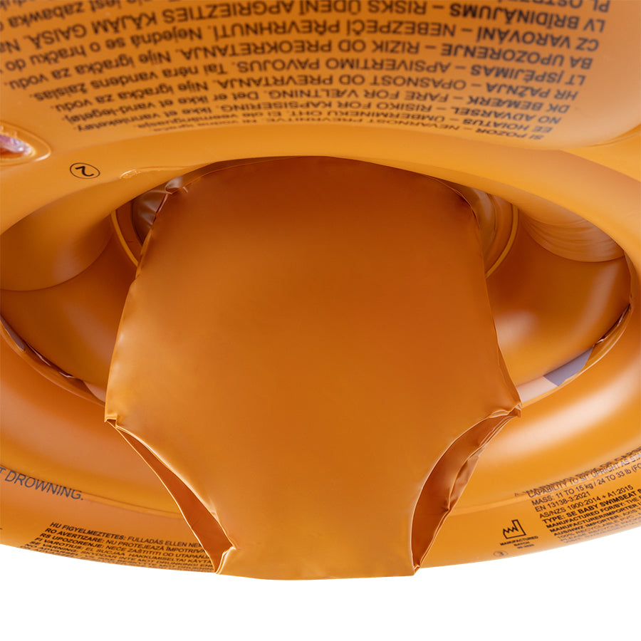Close-up of the brown bottom of the baby float with warnings on it on a white background.