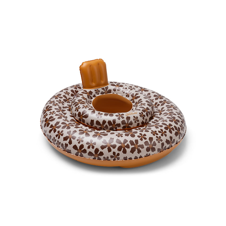 Baby float with a floral pattern, a beige base and brown flowers. The bottom and neck support are finished in a brown color. The picture has a white background.
