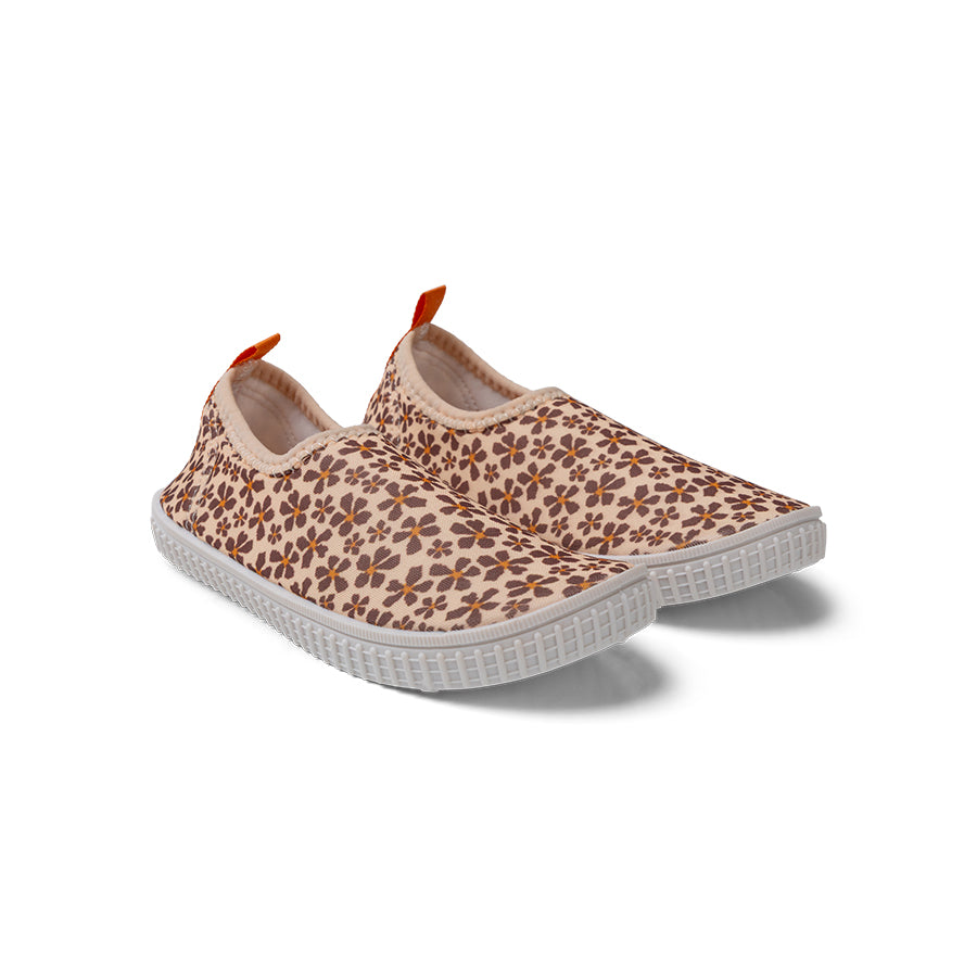 Beige water shoes with a brown floral pattern. The shoe has white soles on a white background.
