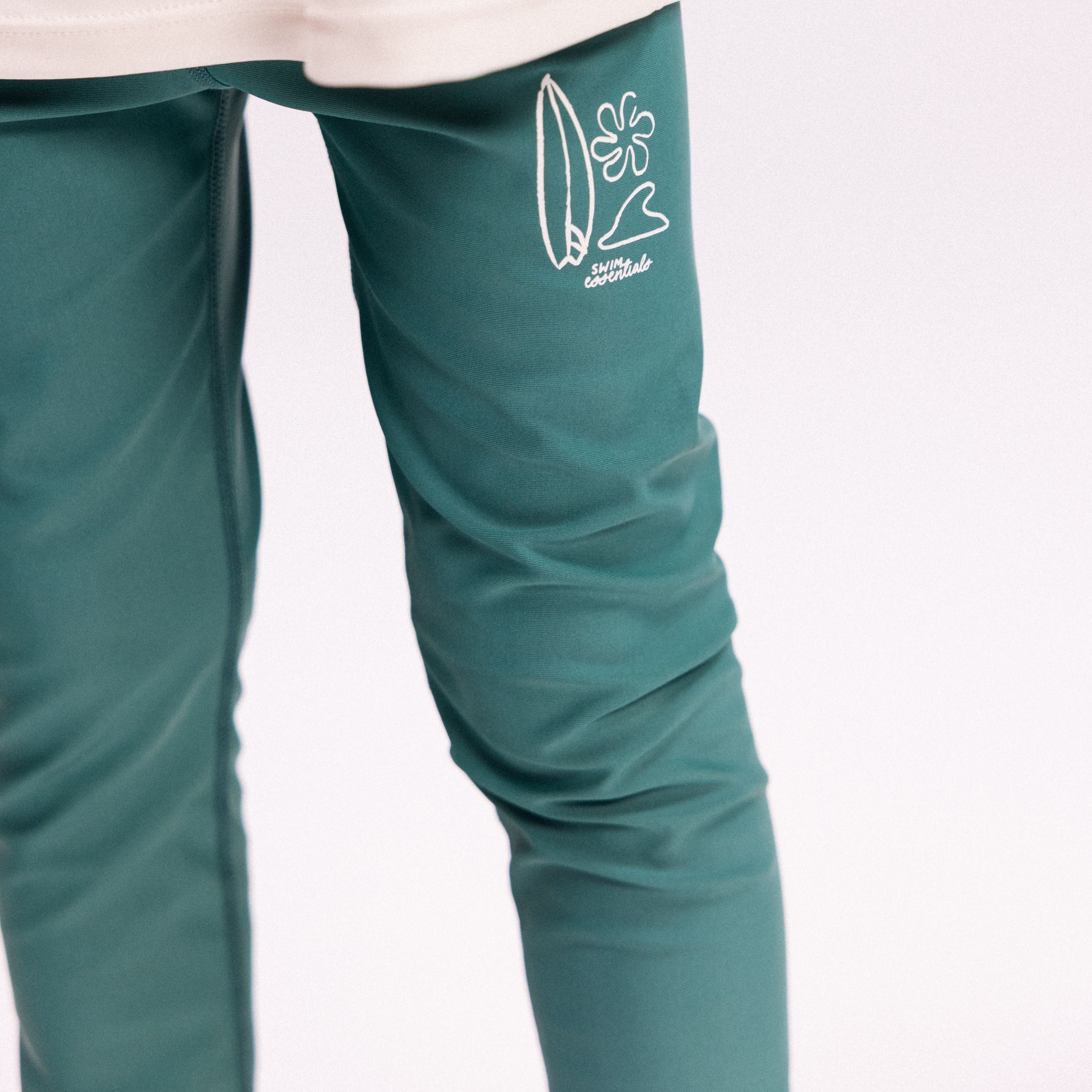 Green leggings with a white logo on a light gray background