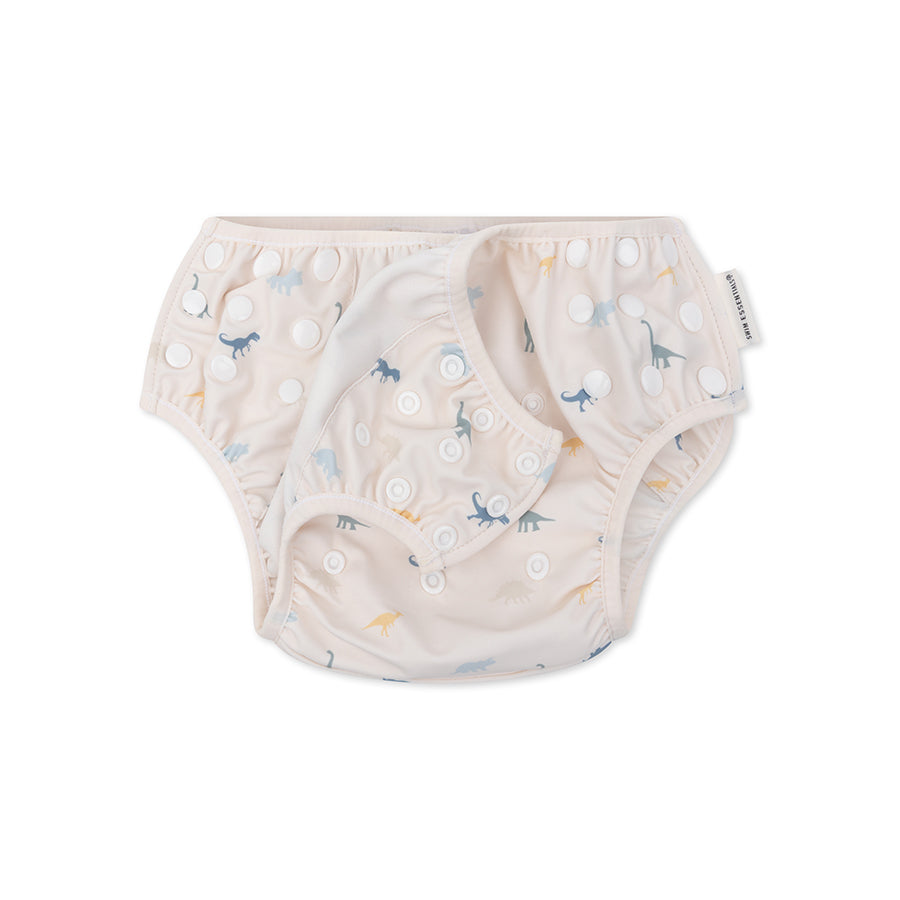 A swim diaper with dinosaur pattern on a white background