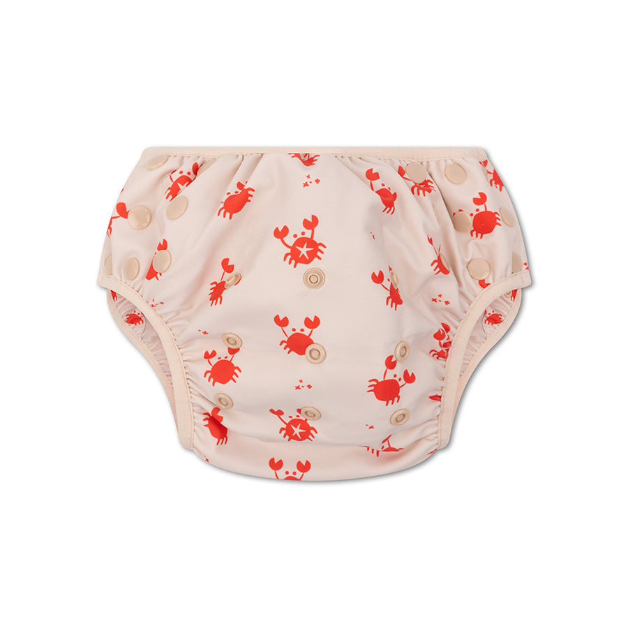 Beige swim diaper with red crab pattern on a white background