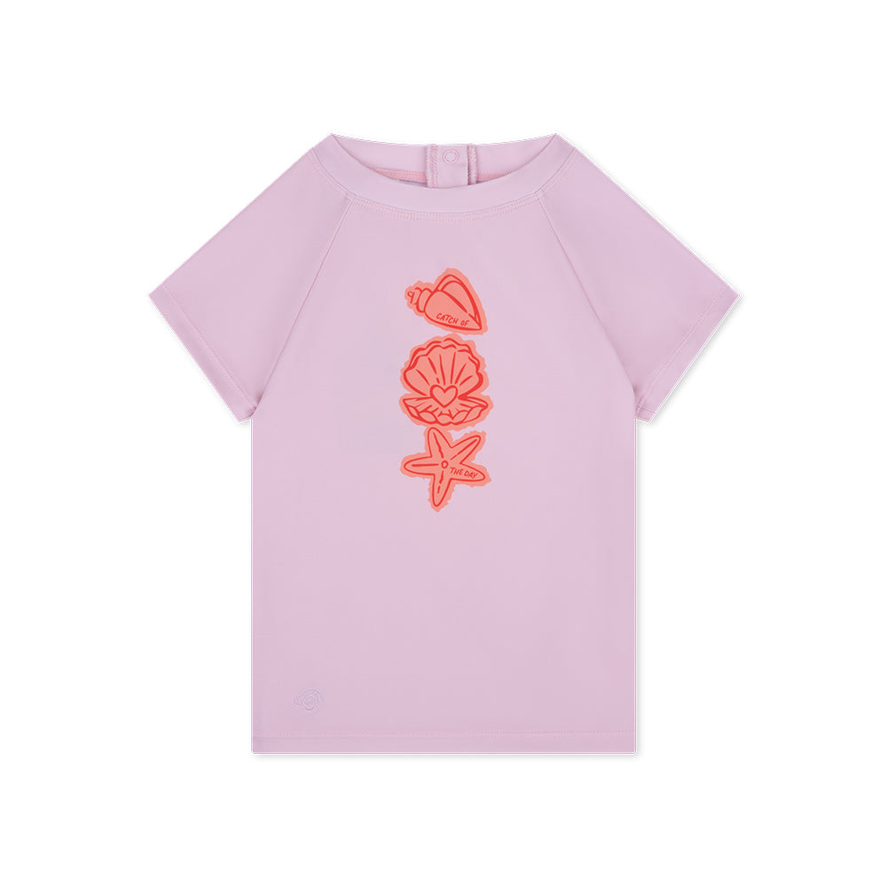 Pink t-shirt with orange shell designs on a white background