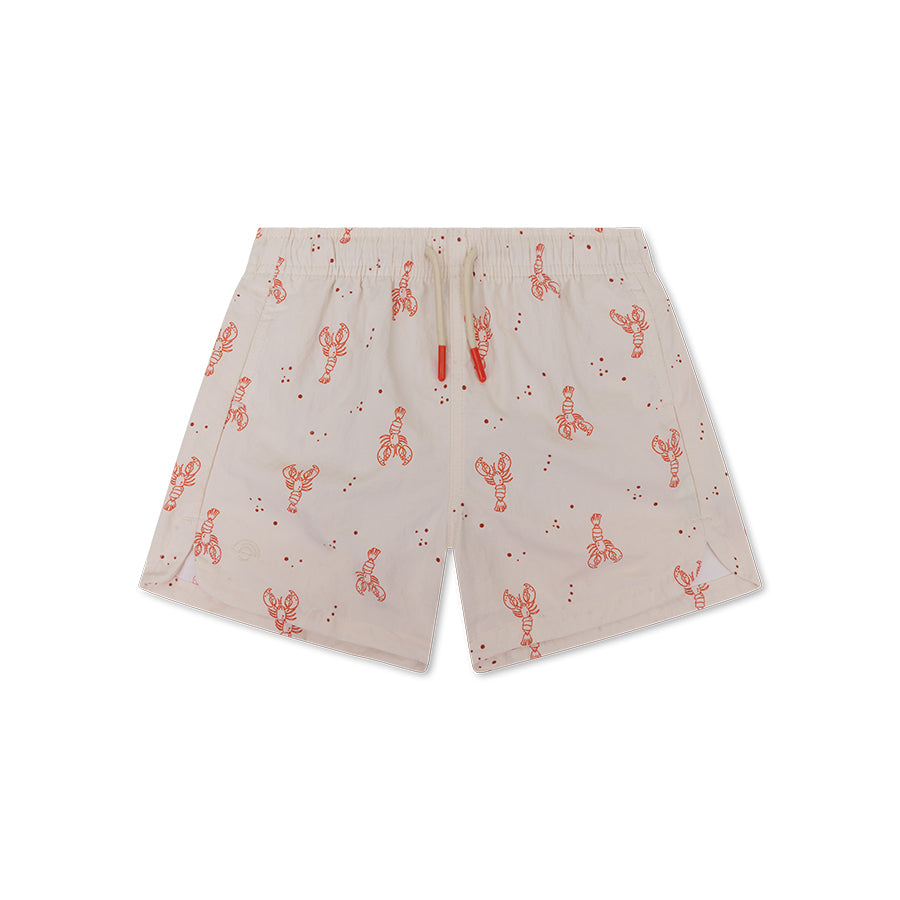 Beige swim shorts with red lobster pattern on a white background