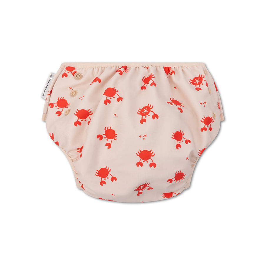 Beige swim diaper with a pattern of red crabs. The swim diaper has snap fasteners to adjust the size. On a white background