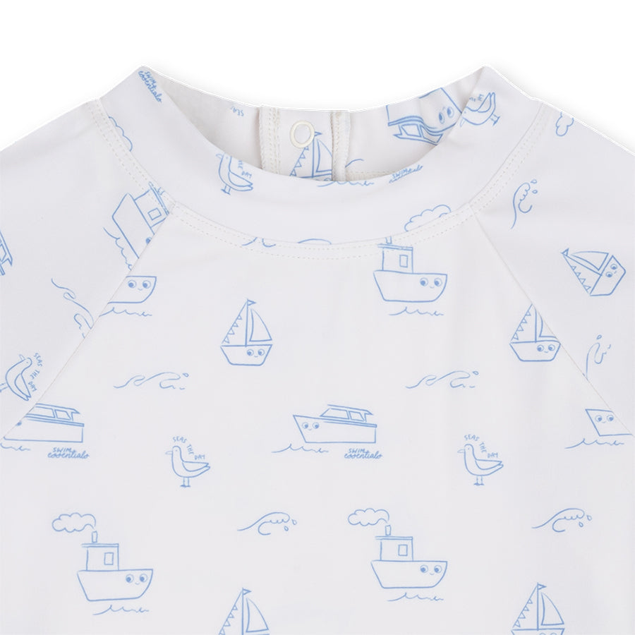 White shirt with blue boat pattern on a white background