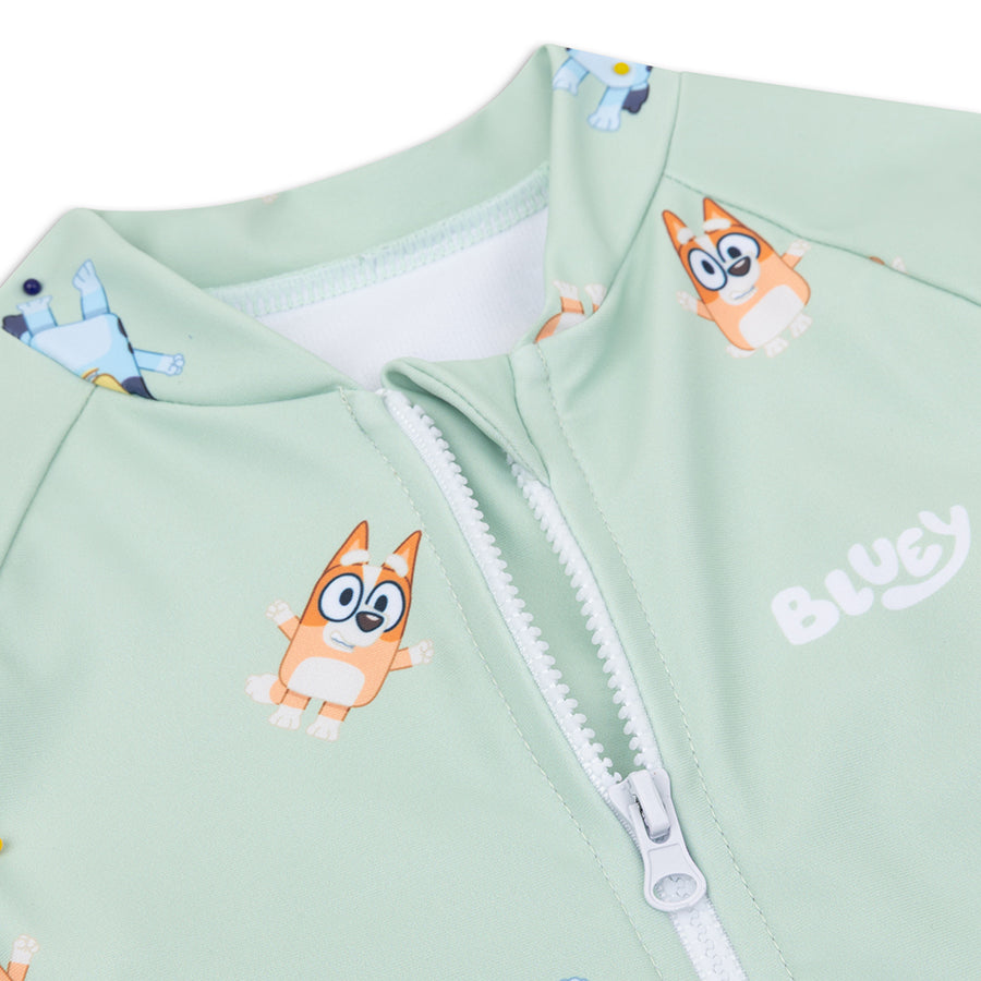 Close-up of a Light green swimsuit with cartoon dog design and 'Bluey' branding.