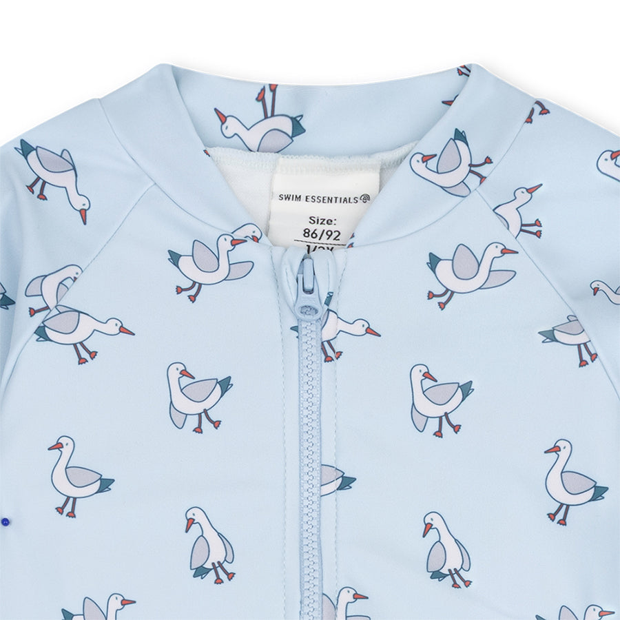 The close-up of a light blue swimuit with seagull
pattern on a white background