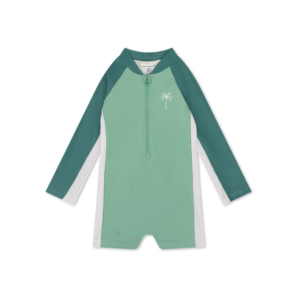 Green and white swimsuit with a palm tree design on a white background