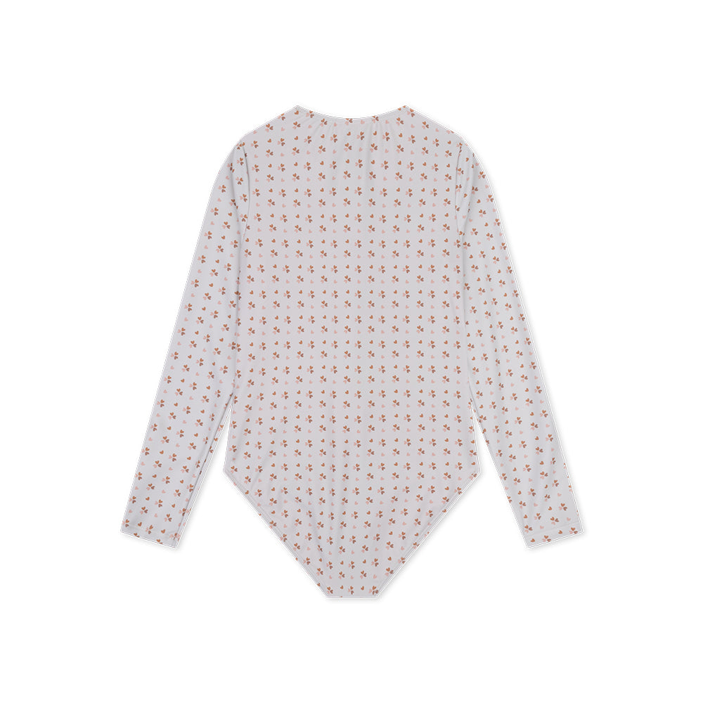 The back of the old pink cozy hearts-patterned long-sleeve swimsuit on a white background