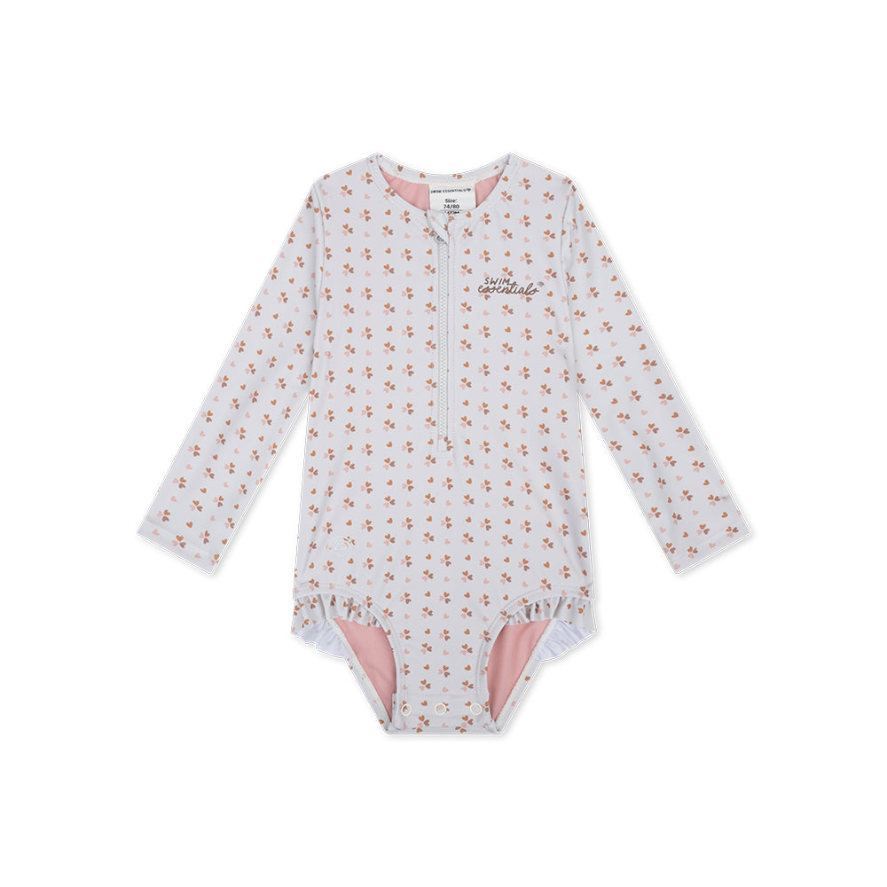 Girls long-sleeve swimsuit with old pink cozy hearts pattern, with a zip and ruffles and a swim essentials logo on a white background